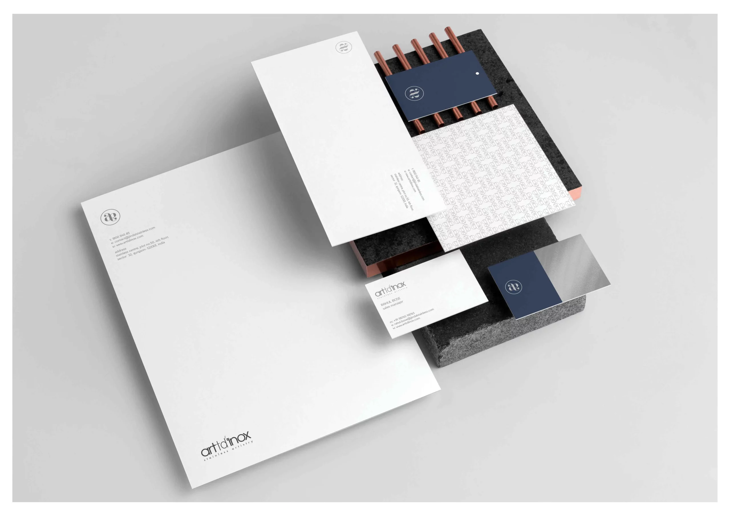 A set of business cards and stationery on a white surface.