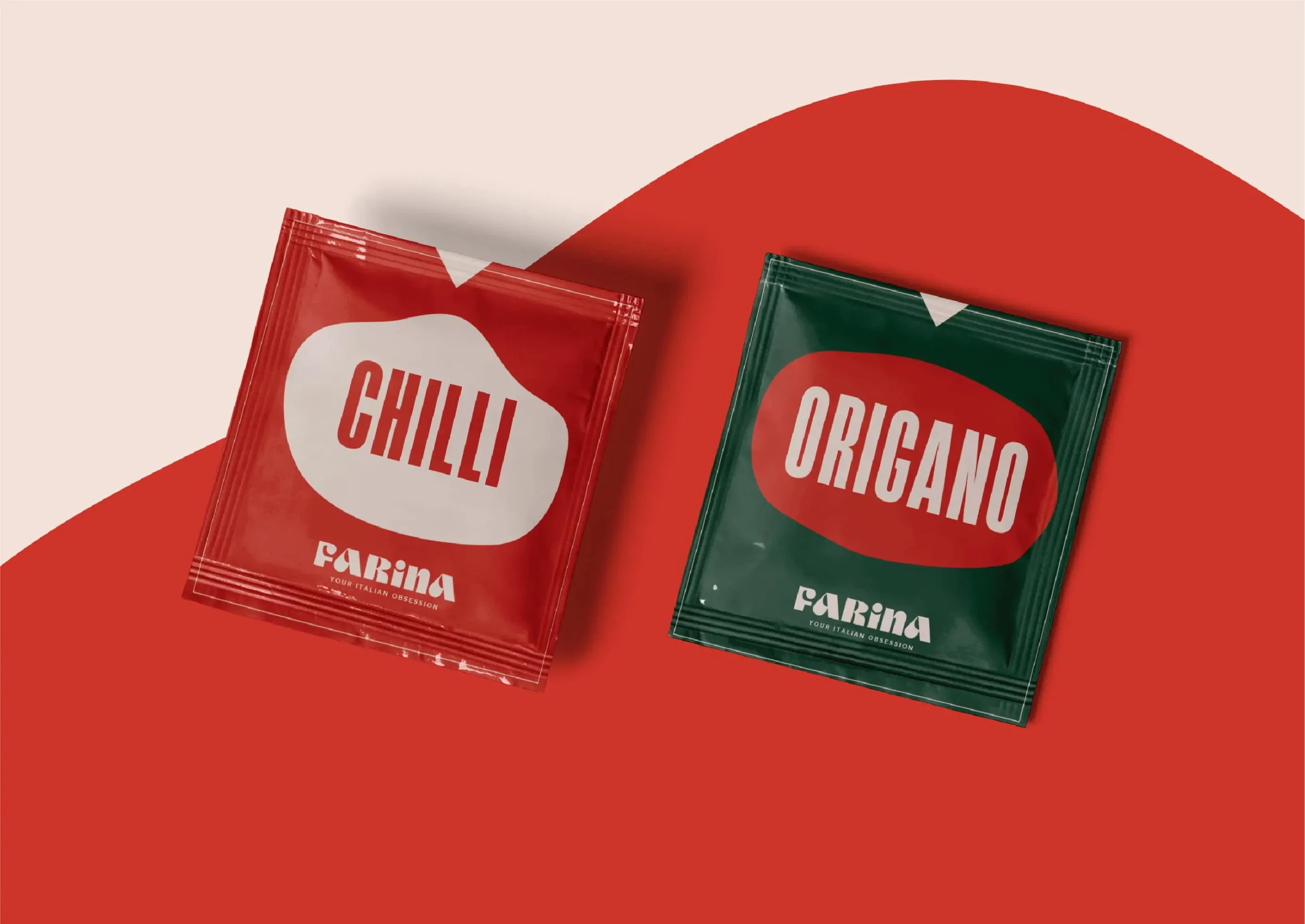 Two packets of chilli and oregano on a red background.