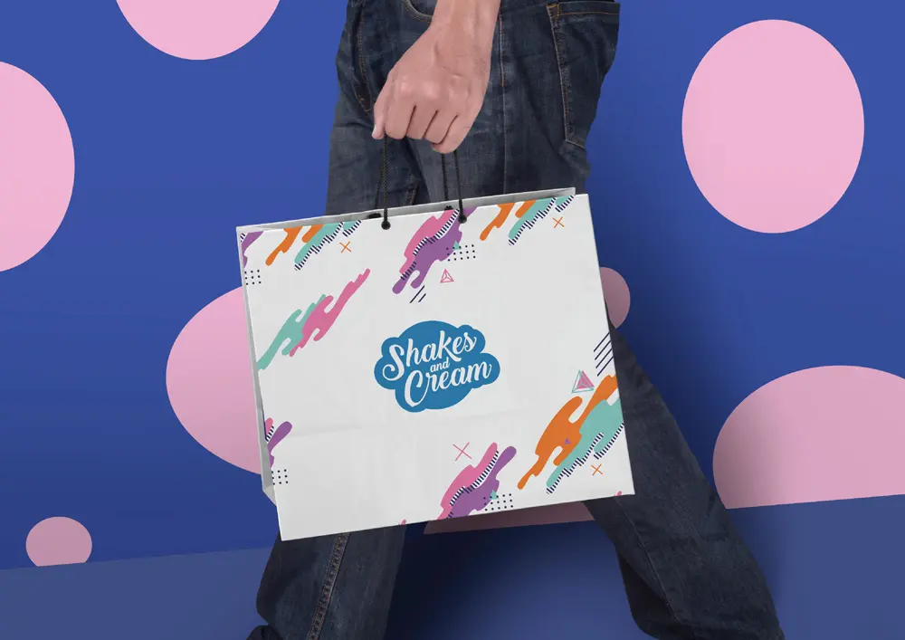 A man is holding a colorful shopping bag.