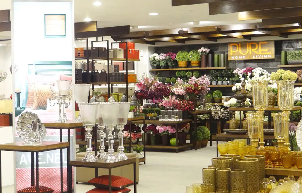 The interior of a store with many vases and flower pots.