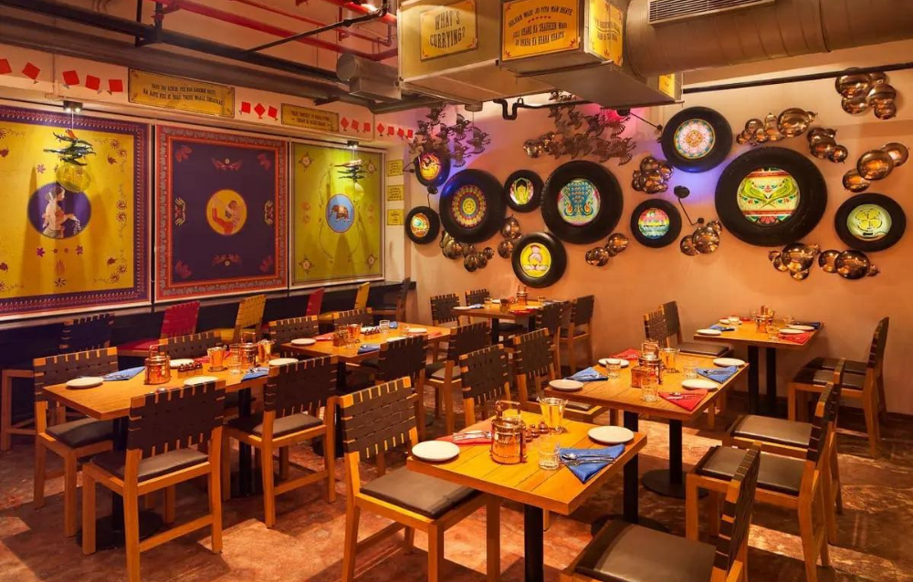 A restaurant with tables and chairs in a colorful setting.
