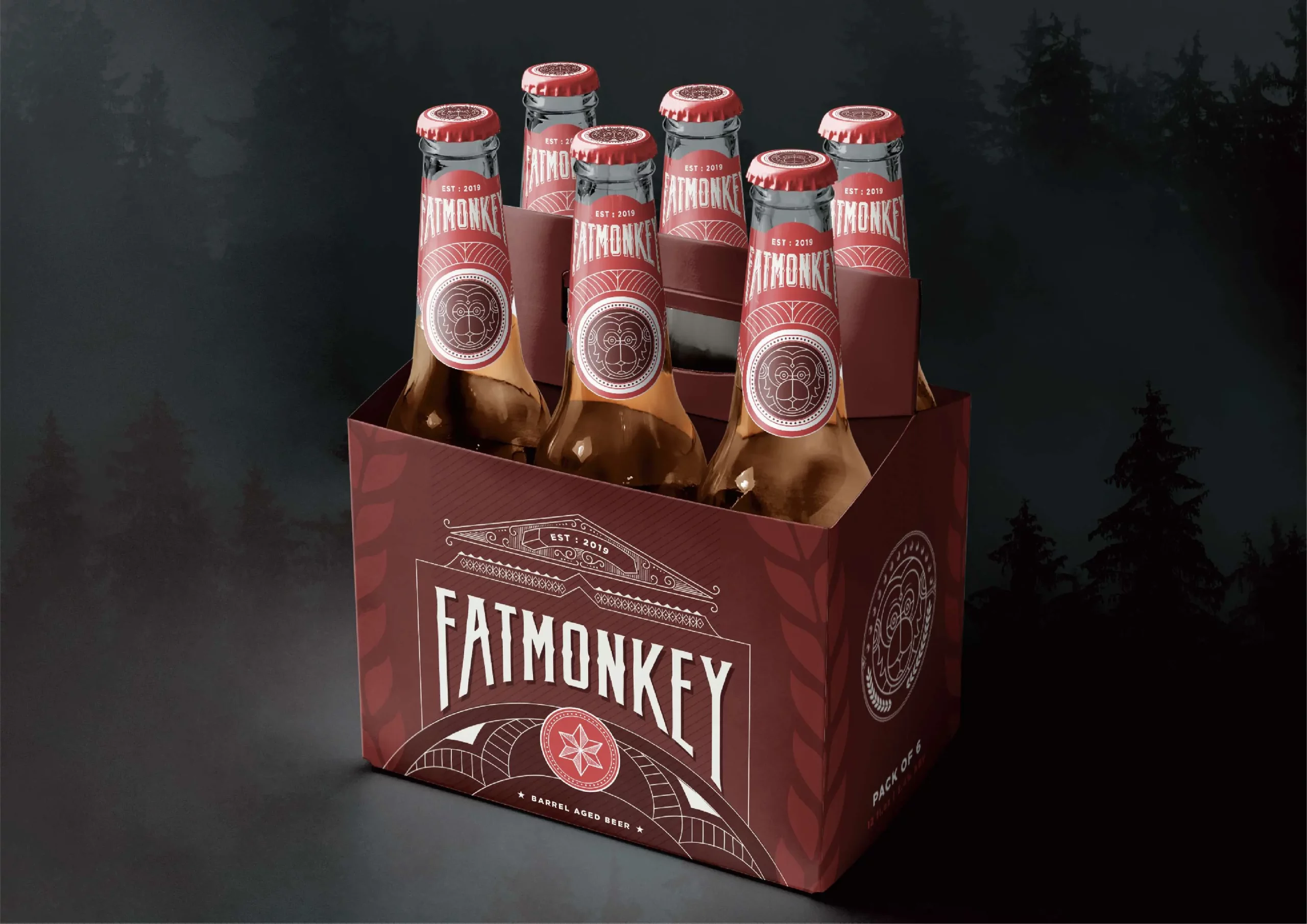 Six bottles of beer in a box in front of a forest.