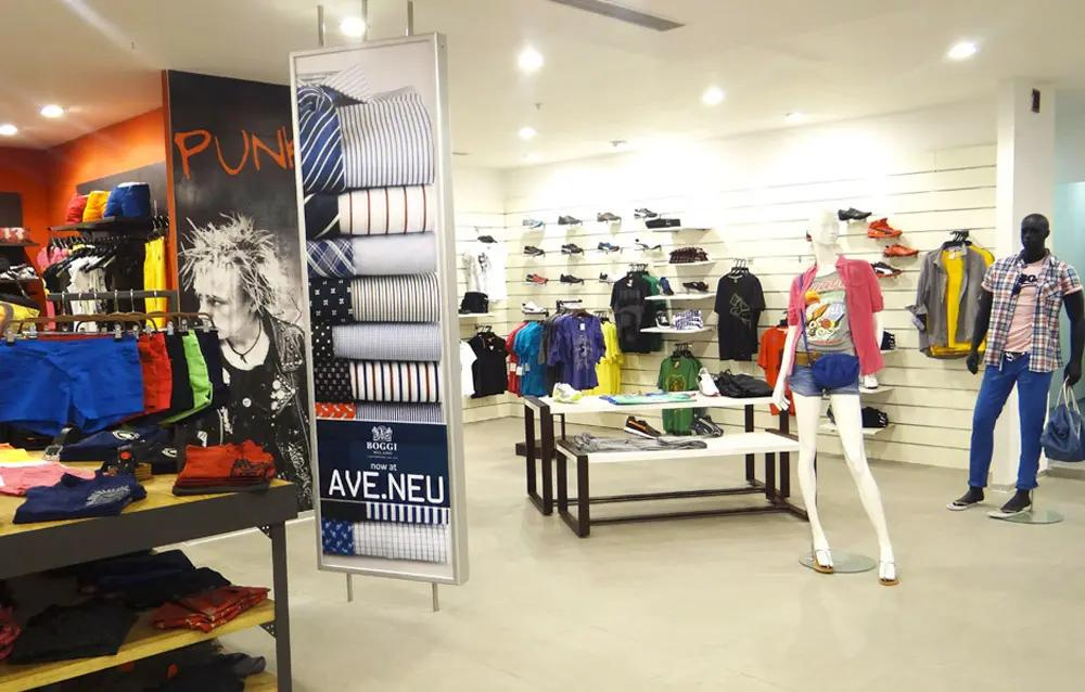 A clothing store with mannequins and clothes on display.