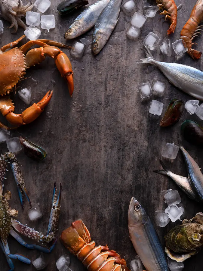Fresh seafood in a circle on a wooden table.