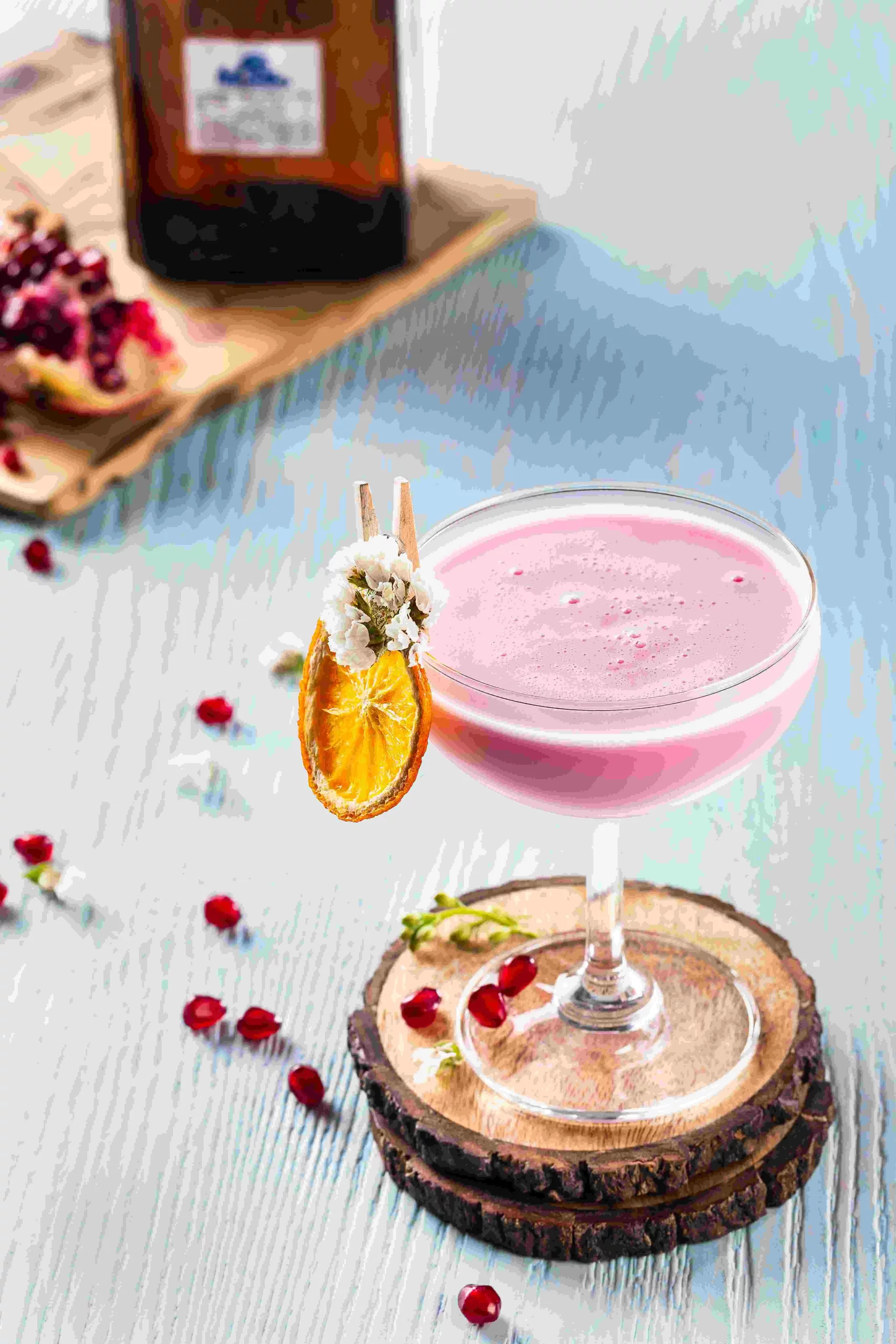 A pink cocktail with pomegranate.
