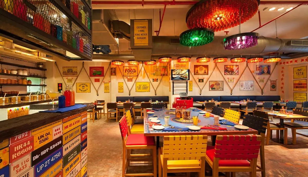 A restaurant with colorful tables and chairs.