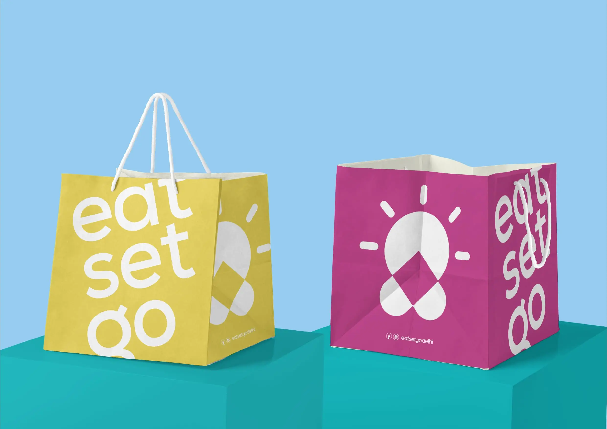 Two shopping bags with the words eat set go on them.