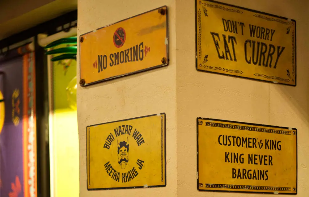 A group of signs hanging on a wall.