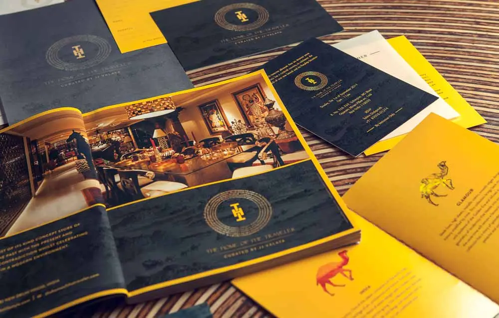 A black and yellow brochure with a gold logo on it.