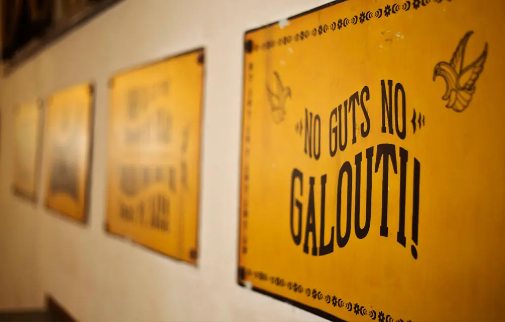 A group of yellow signs hanging on a wall.