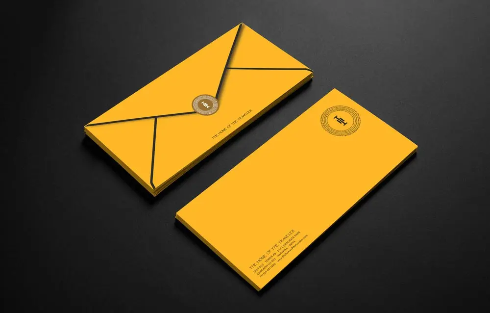 A yellow envelope and business card on a black background.