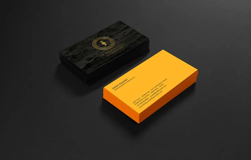 A black and yellow business card on a black background.
