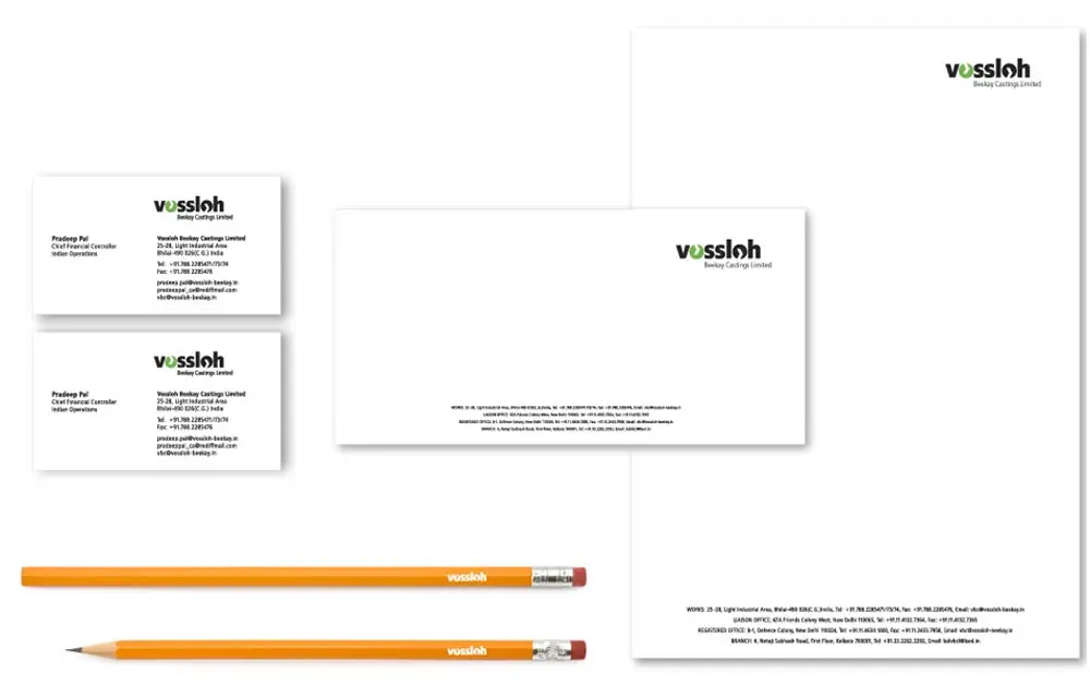 A business card, letterhead, envelope and pencil.