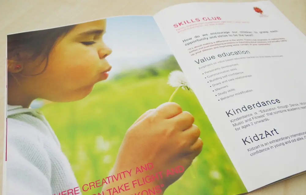 A brochure with a picture of a girl blowing a dandelion.