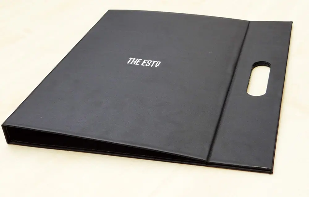 A black folder with the word the city on it.