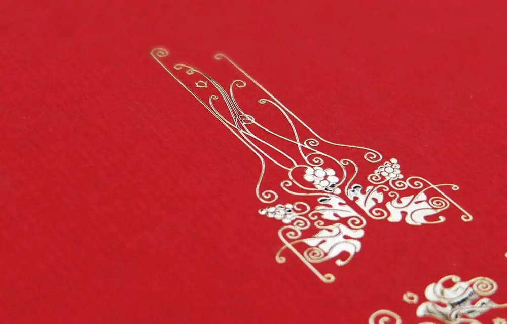 A red sheet of paper with a gold design on it.