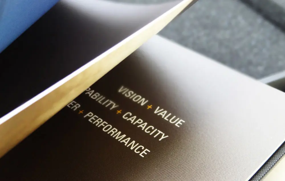 A book with the words vision, value, capability, performance.