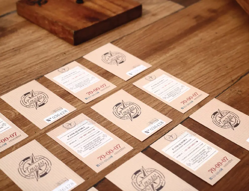 A group of business cards on a wooden table.