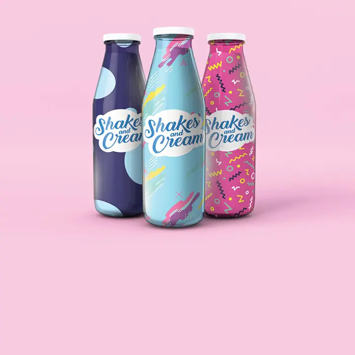Three shake cream bottles on a pink background.